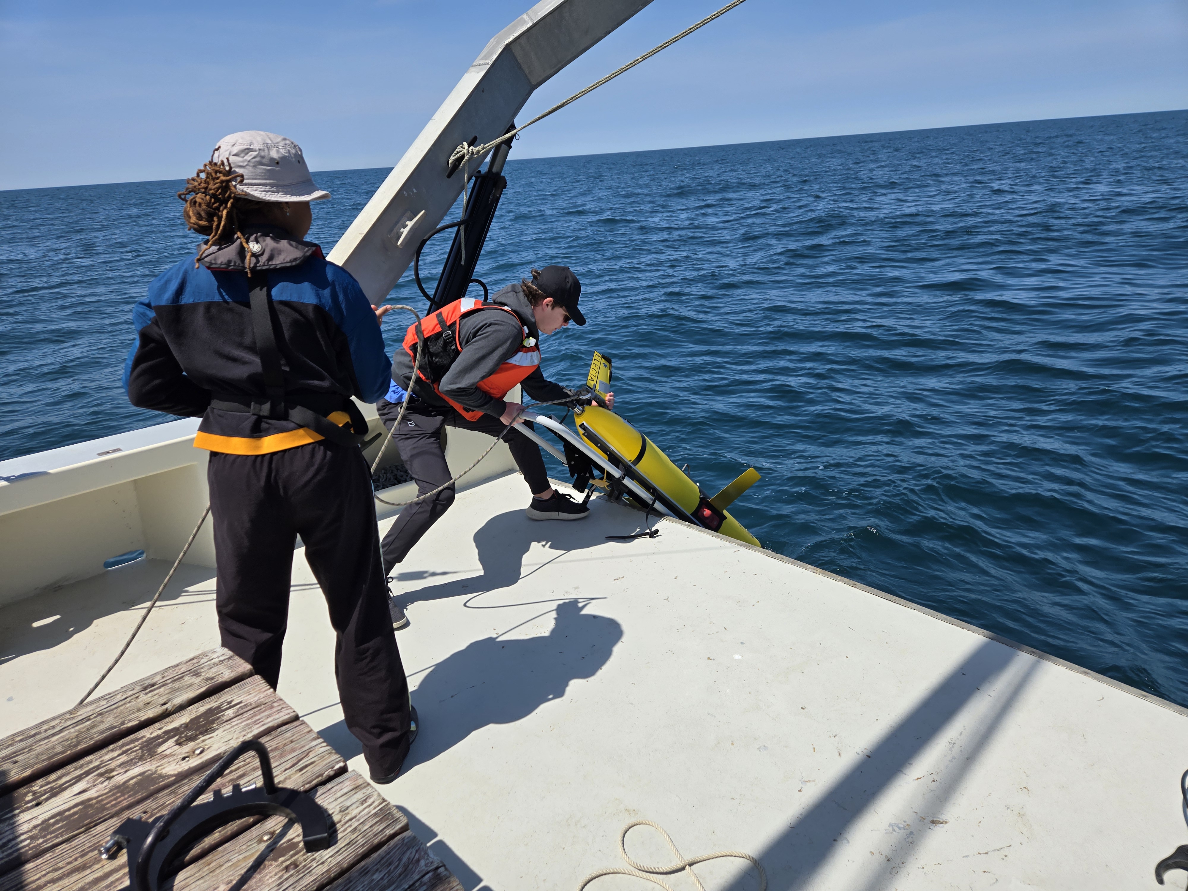 Glider being deployed off the back of a ship by researchers at VIMS